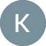 A gray circle with a white, uppercase letter K centered inside. The background is light gray.